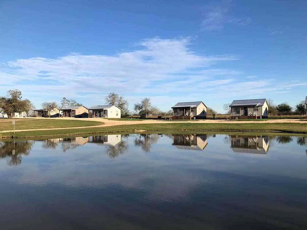Rental cabins reflecting on water at SOUTHBOUND RV PARK AND CABINS