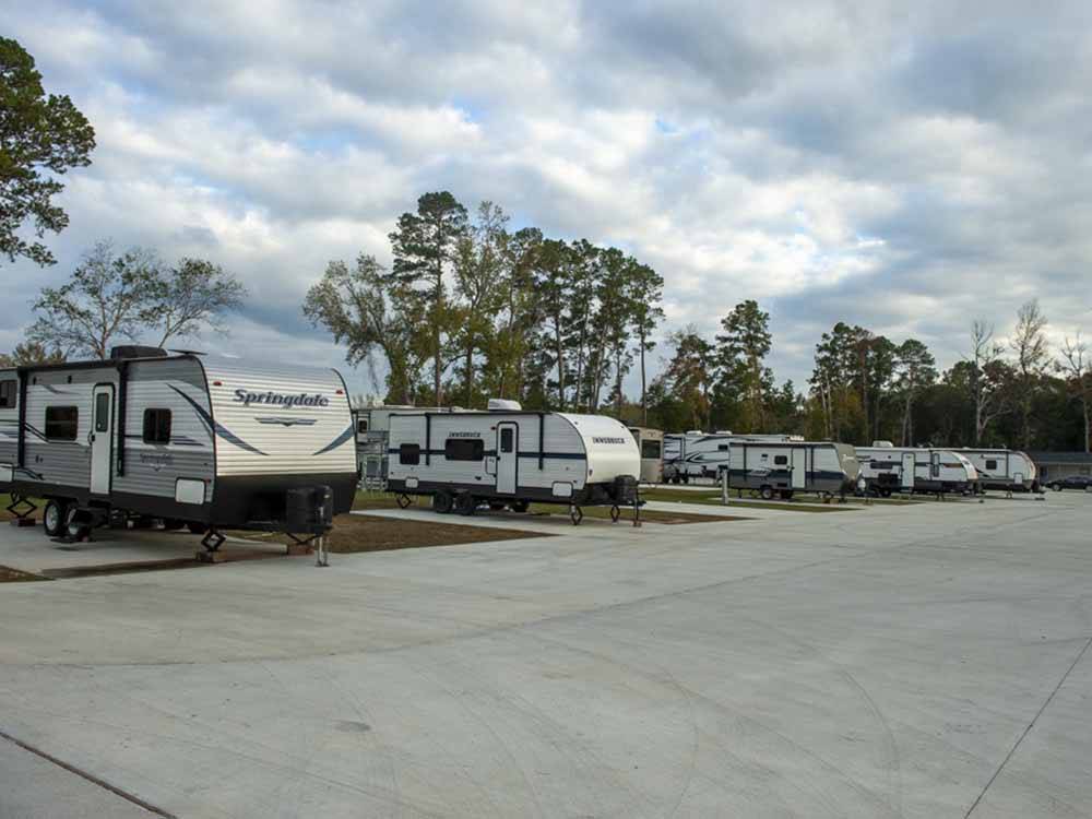 A row of travel trailers parked at ROYAL OAKS RV PARK