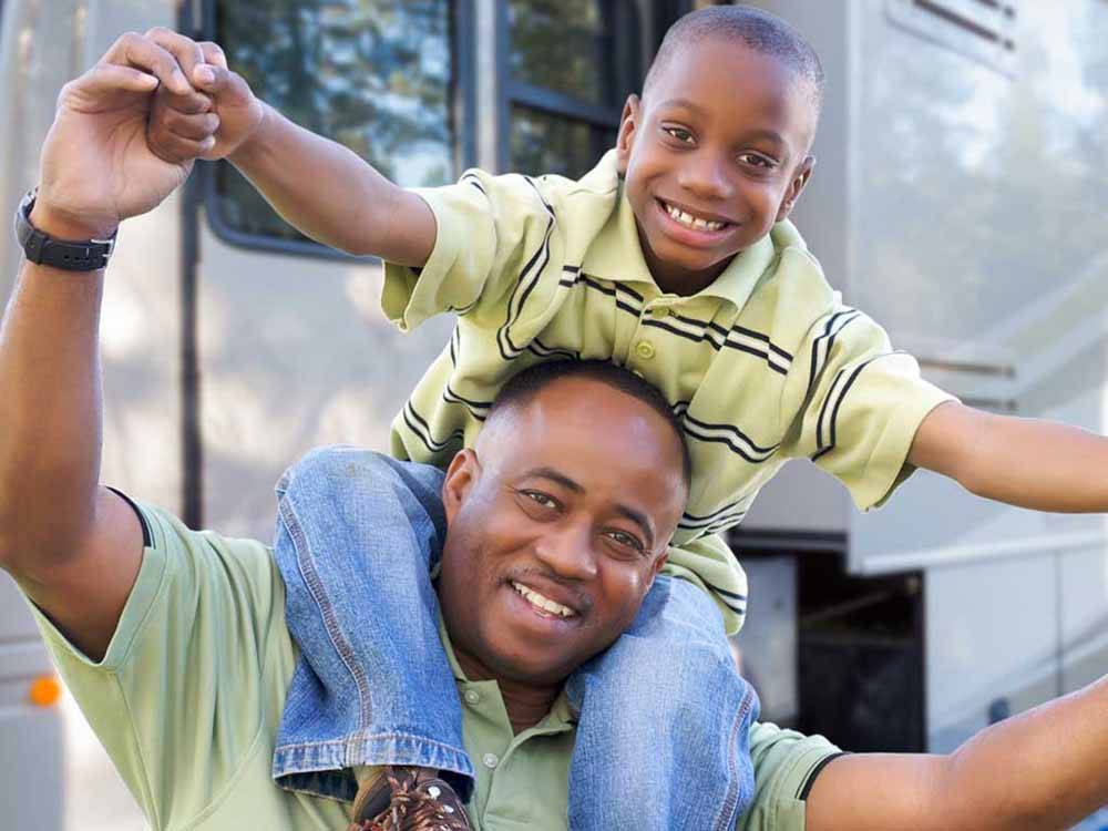 A father and son outside their RV at JETSTREAM RV RESORT AT THE MED CENTER
