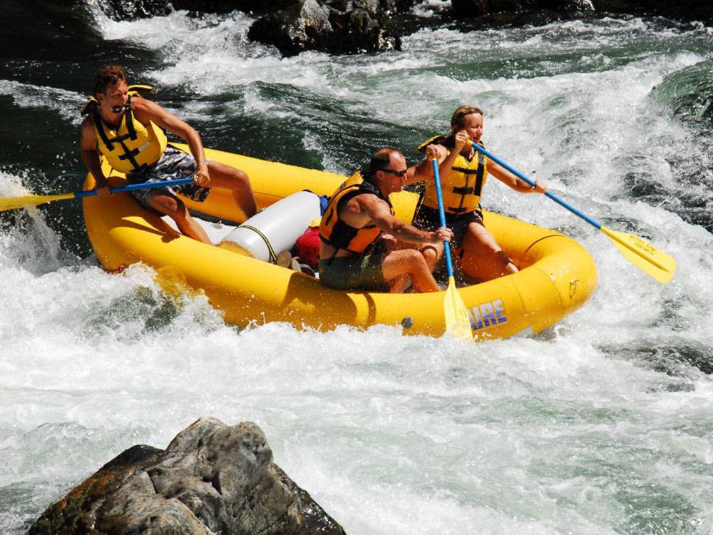 Three people whitewater rafting