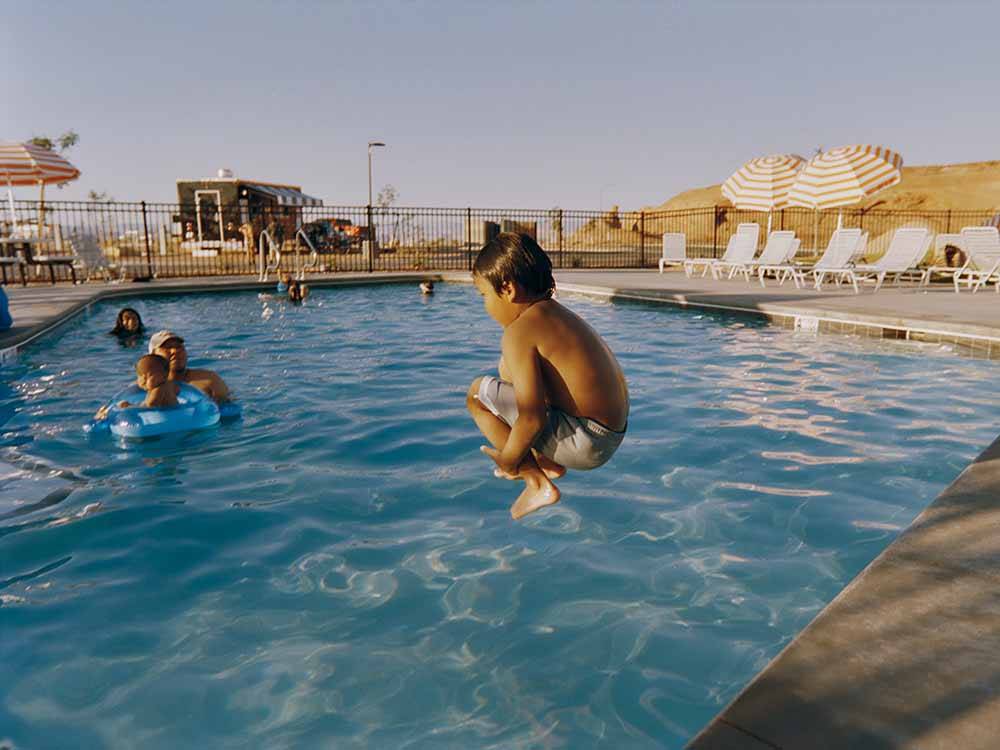 A boy jumps into the pool at ROAM AMERICA HORSESHOE BEND