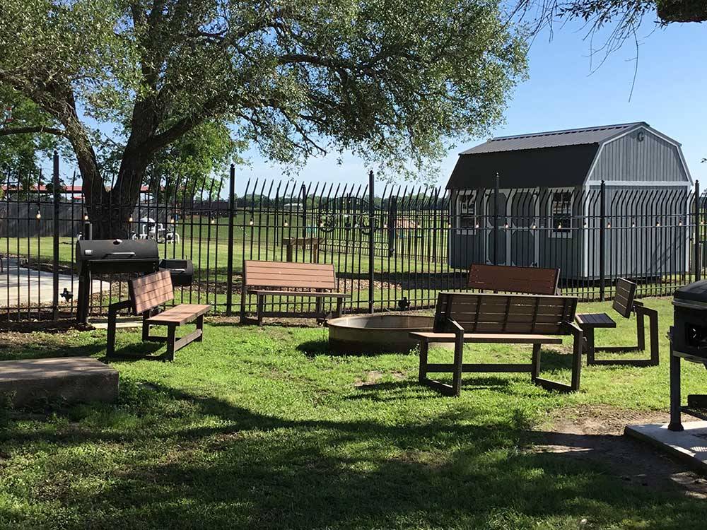 BBQ pit and fire pit sitting area at IRON HORSE RV RESORT