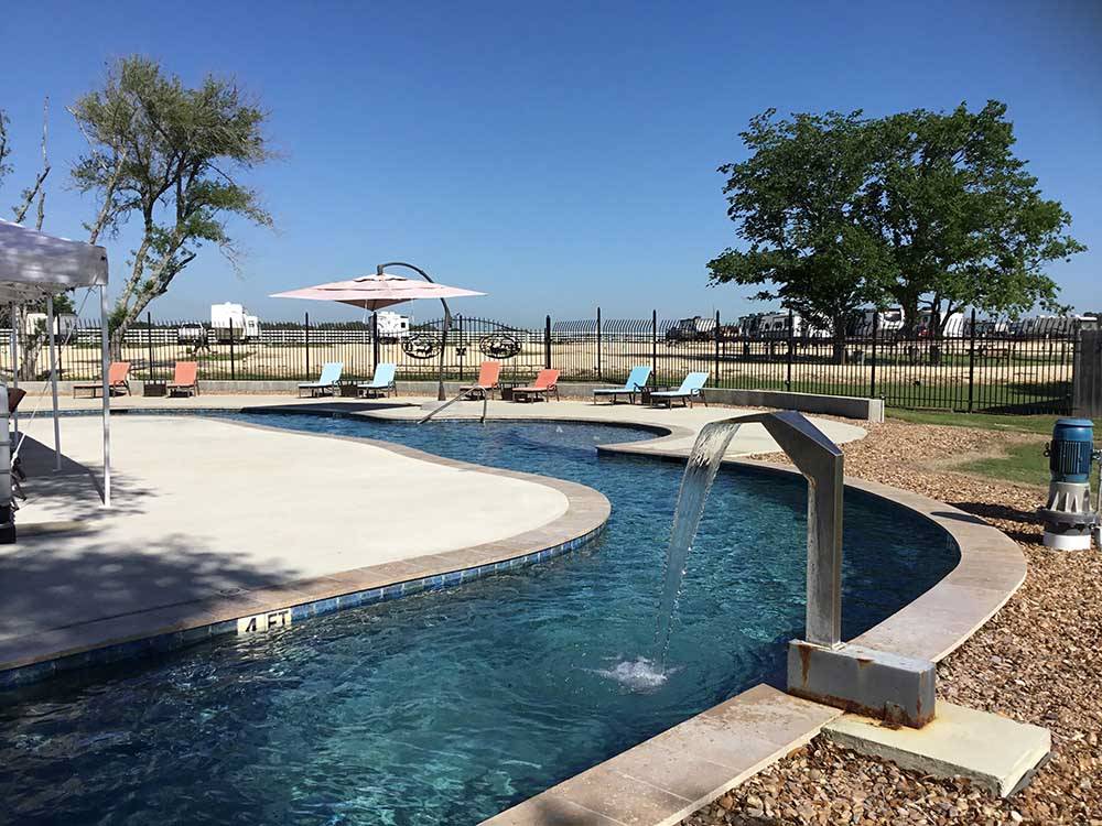 The lazy river with a fountain at IRON HORSE RV RESORT
