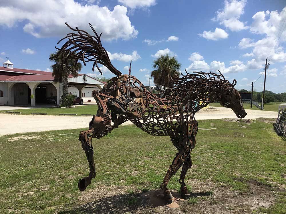 A horse made out of metal in front of the office at IRON HORSE RV RESORT