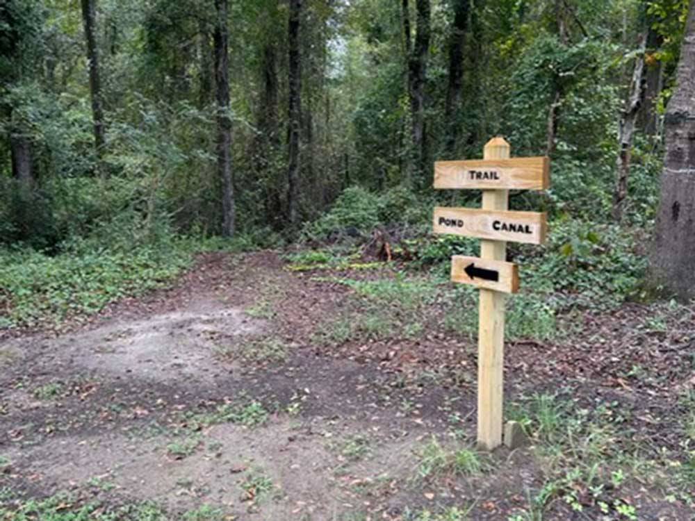 A directional sign in the woods at MIDPOINT I-95 RV PARK