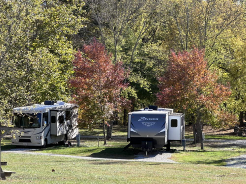 Two RVs parked by trees at The Resort at Boiling Springs