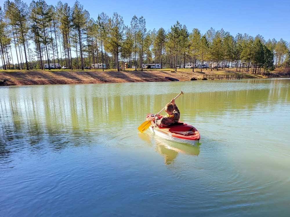 A boy in a boat in the river at DREAM RV PARKS