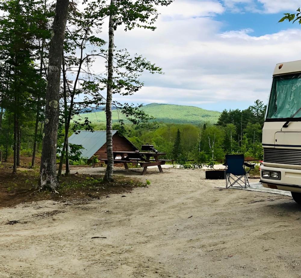 Panic area with RV and cabin at site Lone Mountain River Front Campground