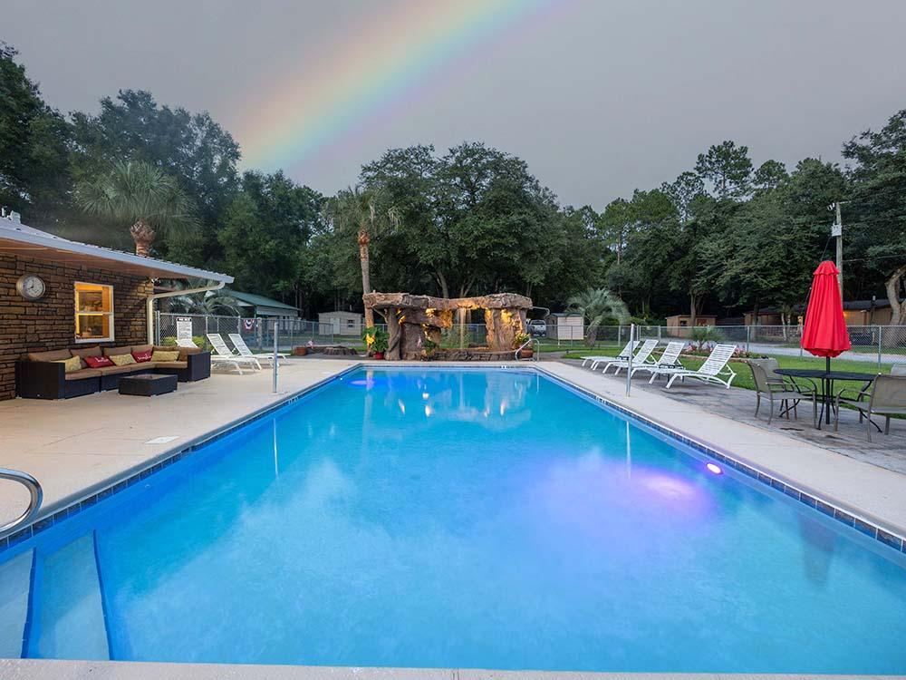 The pool area at dusk with a rainbow at VACAY VILLAGE OF PENSACOLA