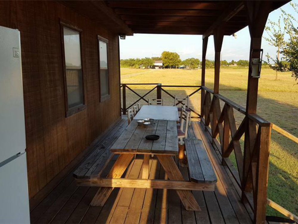 Wooden table on a wooden deck at M Bar H Lodge and RV Park
