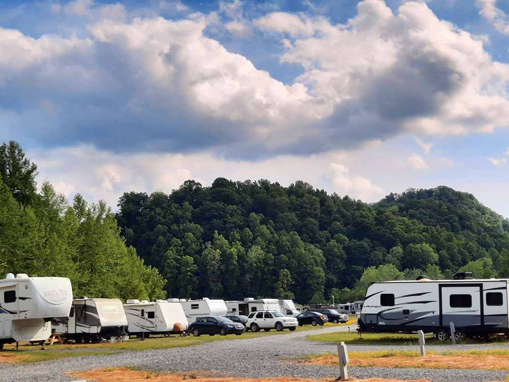 A row of travel trailers parked in gravel sites at MAMMOTH RIDGE RV PARK