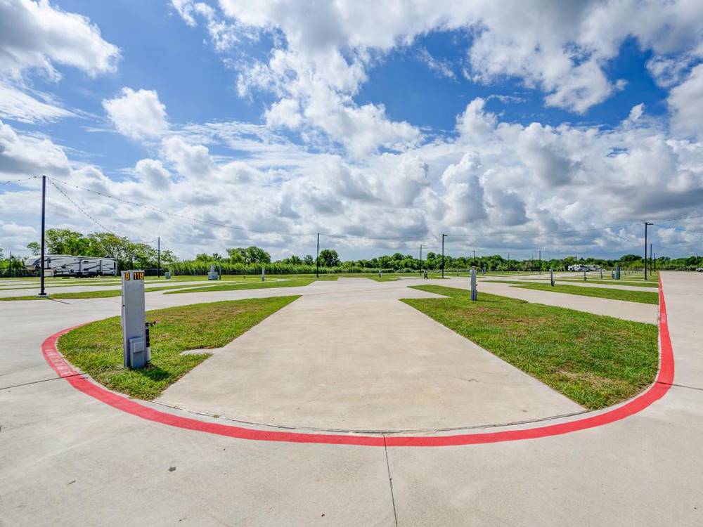 Long paved site flanked with grass at Medical Center RV Resort