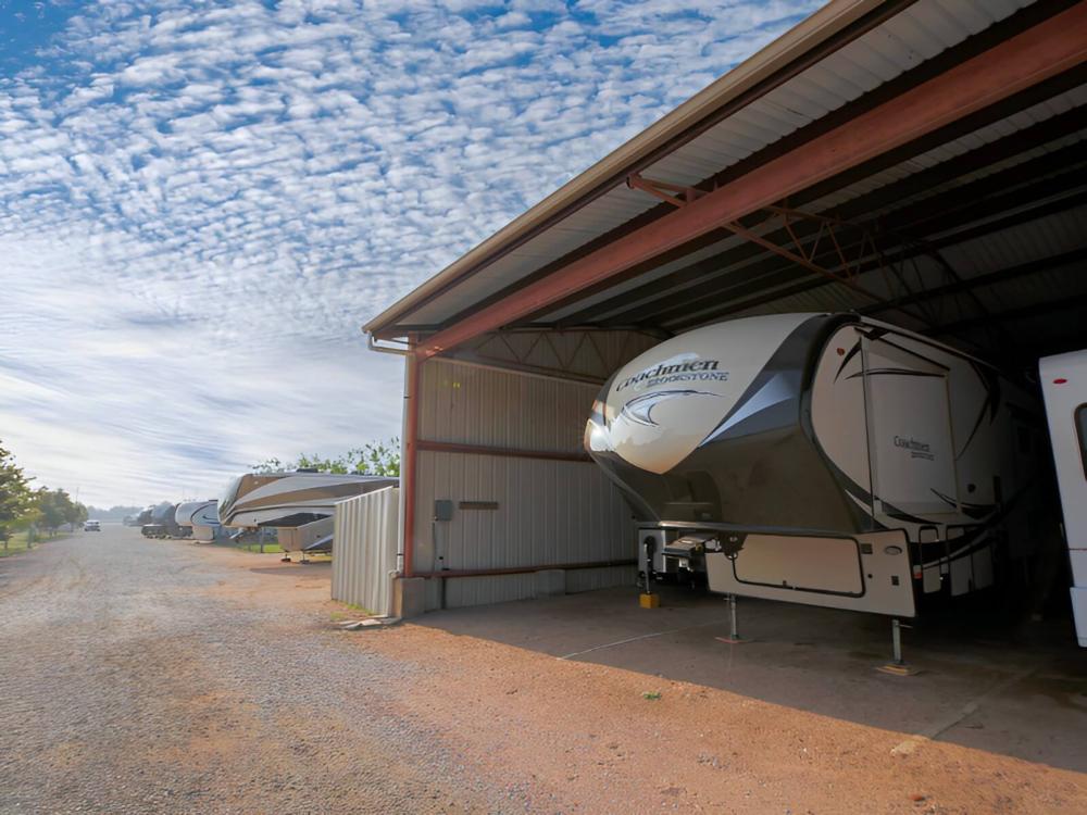 Covered parked trailer at site Miller Creek RV Park