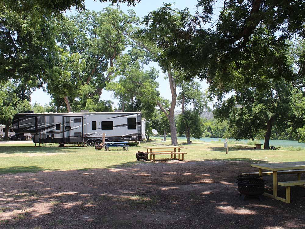 A fifth wheel parked in a RV site at MORGAN SHADY RV PARK