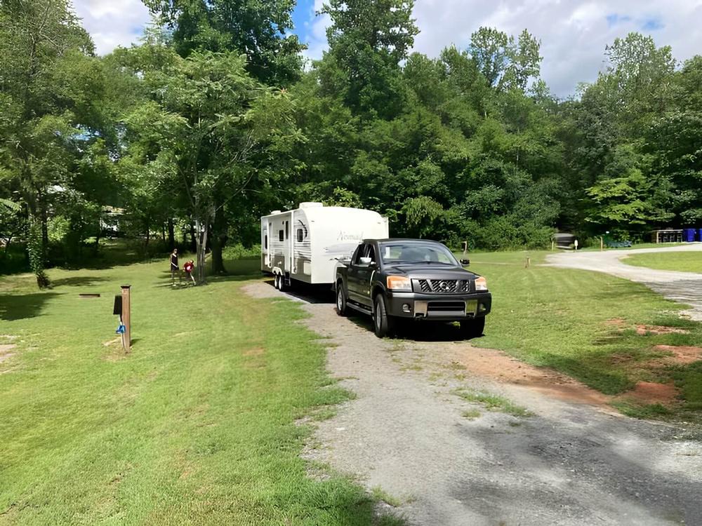 Truck and trailer in a site at Emberglow Outdoor Resort