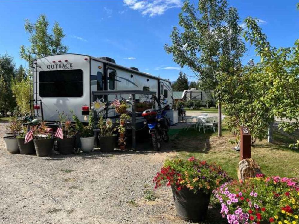 RV site with plants and flowers at North Haven Campground