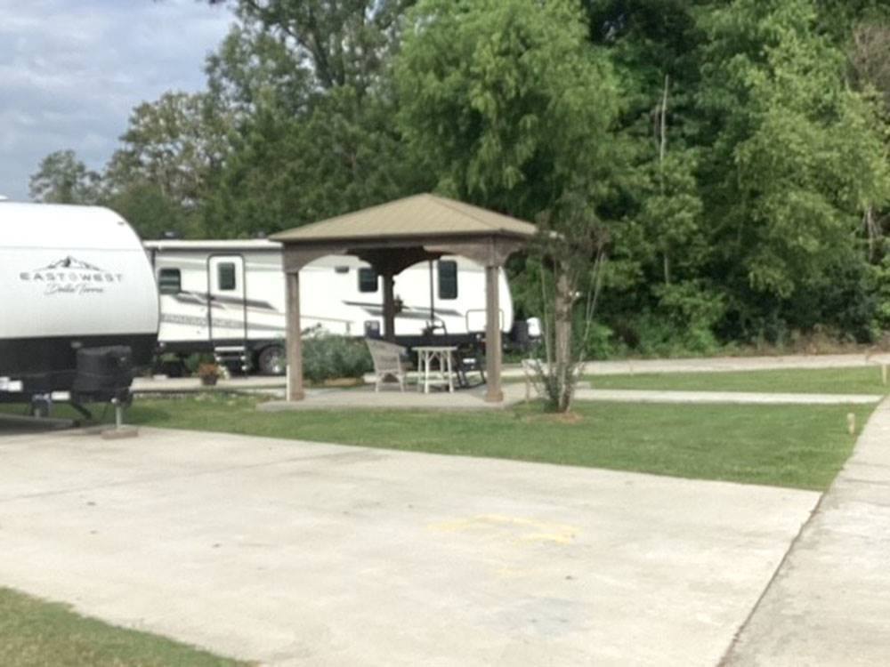 Covered sitting area next to a site at Gator RV Park