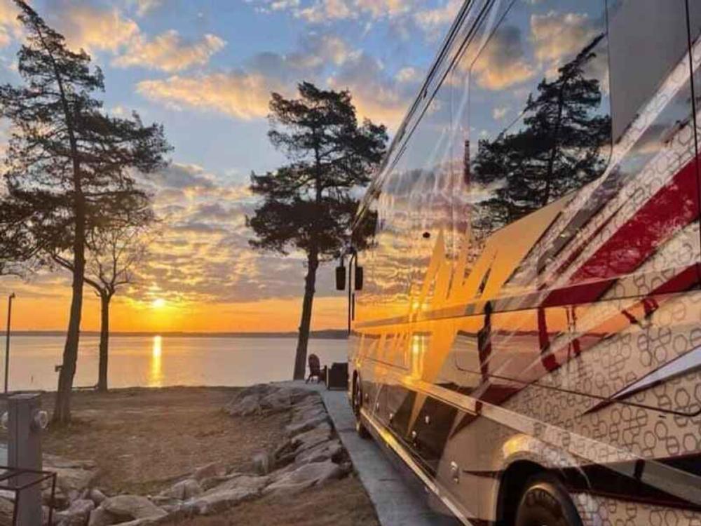 A class A parked on a paved site at sunset at The Regatta on Grand RV Resort