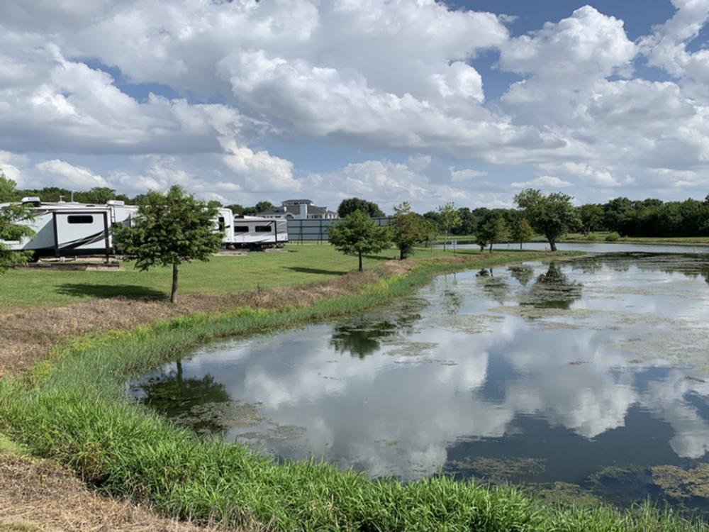 View of an RV site by the water at Plantation Place RV Park