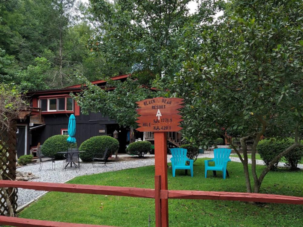 Sign and blue Adirondack chairs at Black Bear Resort