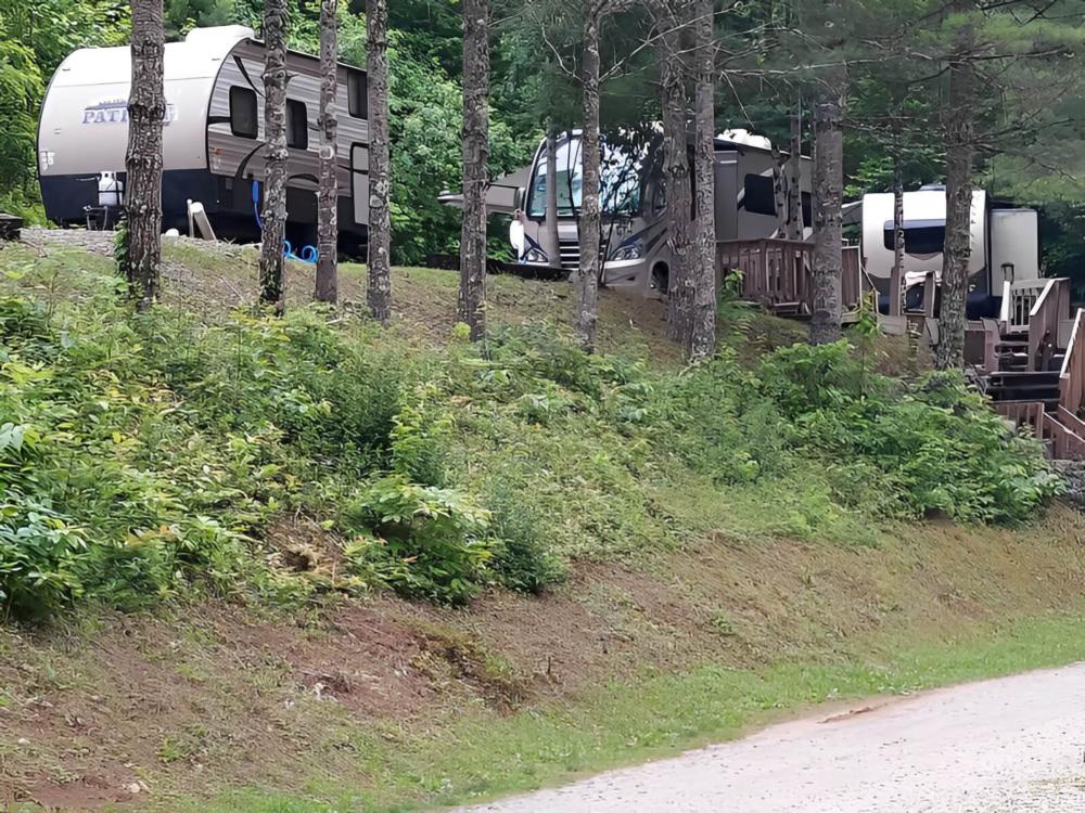 Parked RV and trailers at site Black Bear Resort