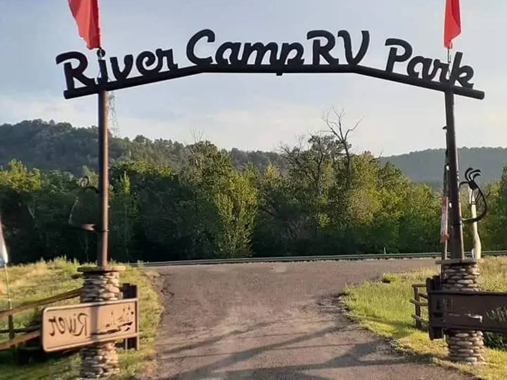 "River Camp RV Park" arch leading into RV Park