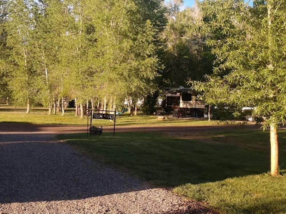 Grassy lawn next to road, overlooking RV campground