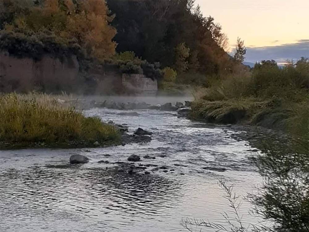 River running through a valley at sunset