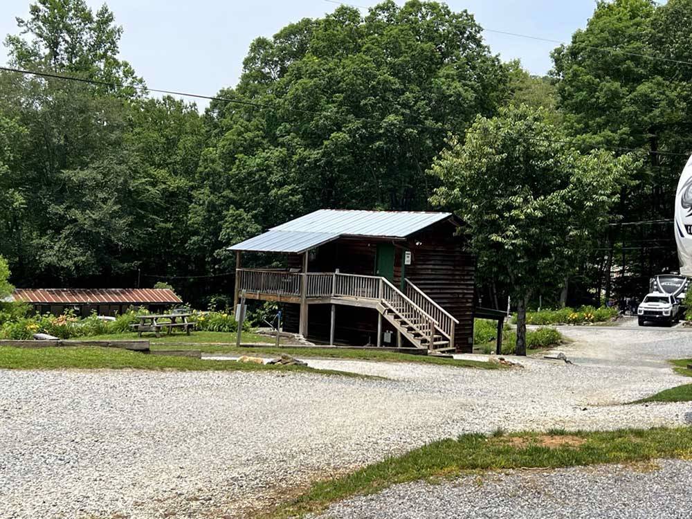 A two story building with a picnic bench at PLUMTREE CAMPGROUND AND RETREAT