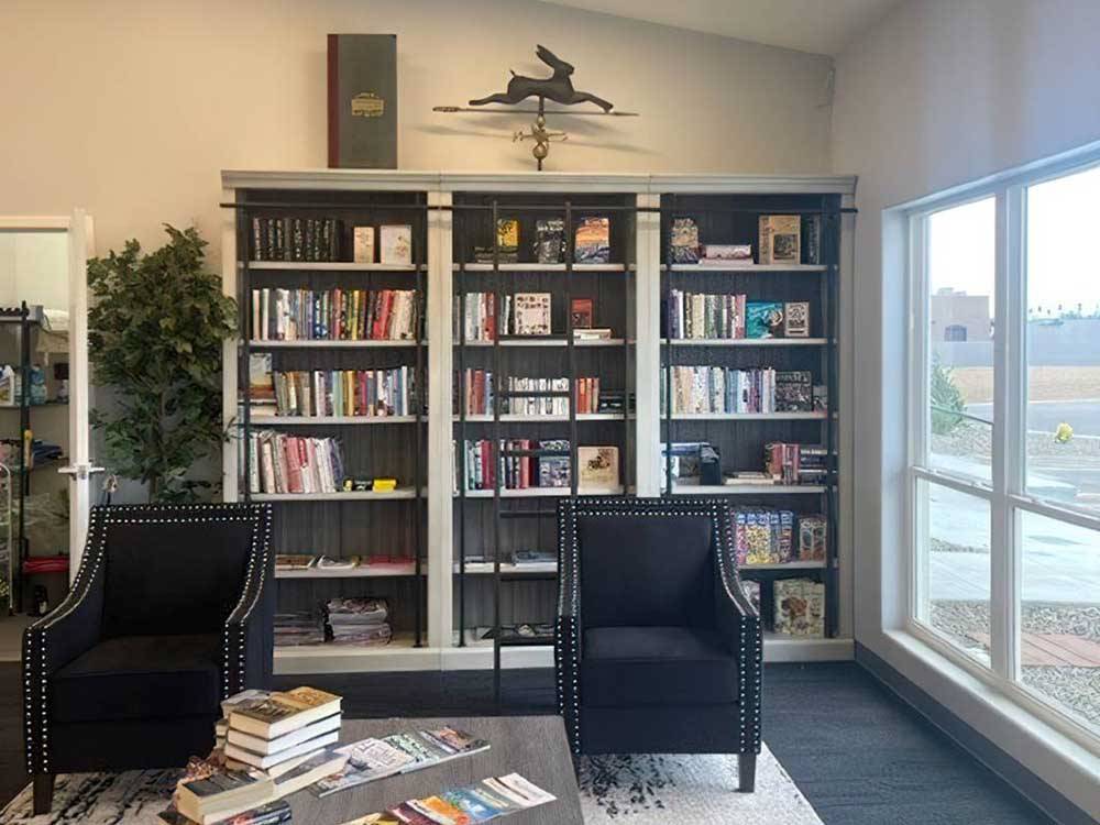 A large bookshelf in the dining area at WHISTLESTOP LUXURY RV PARK