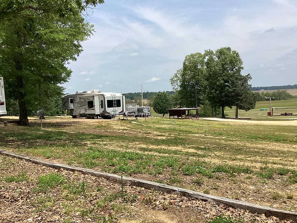 RVs parked in gravel sites at CORINTH RV PARK