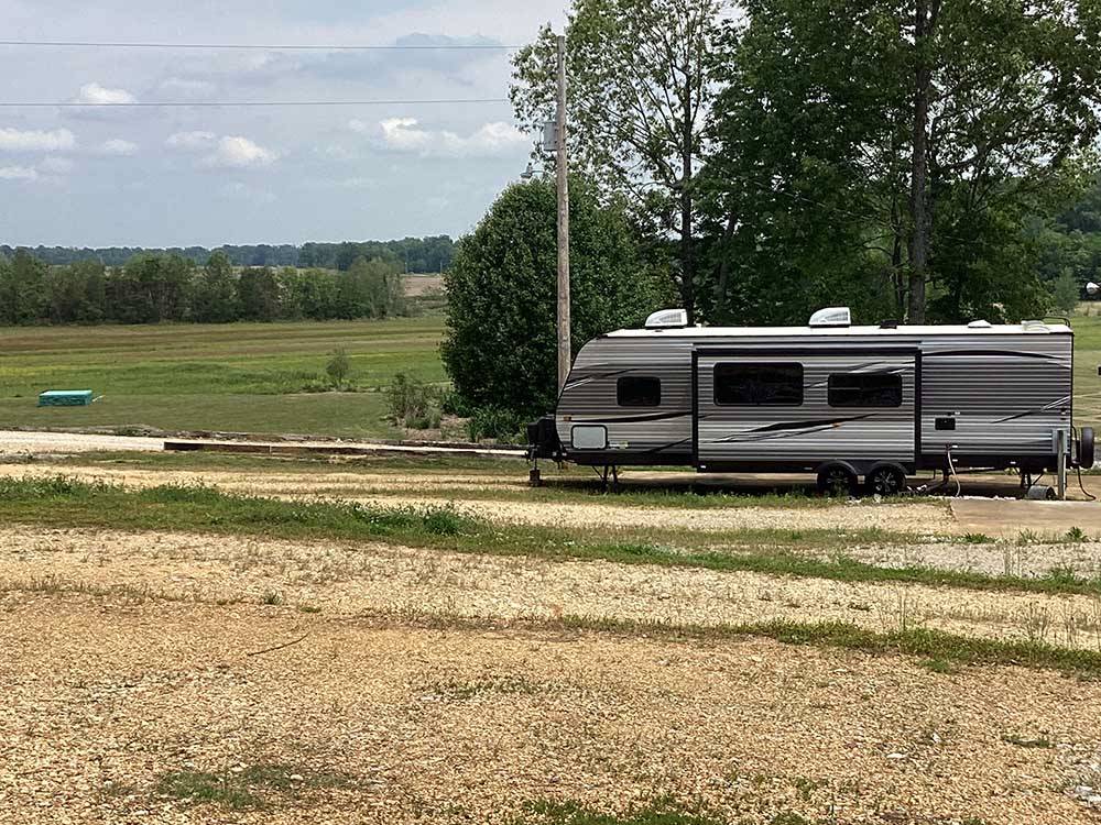 A travel trailer in a gravel site at CORINTH RV PARK