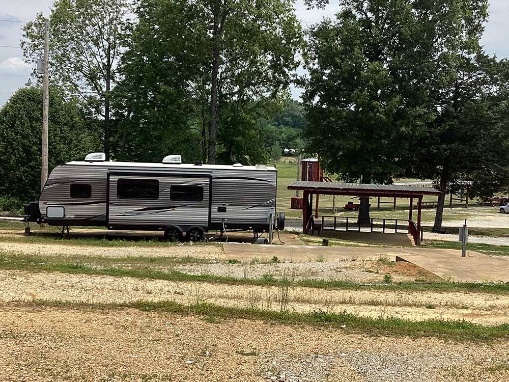A trailer parked next to a pavilion at CORINTH RV PARK