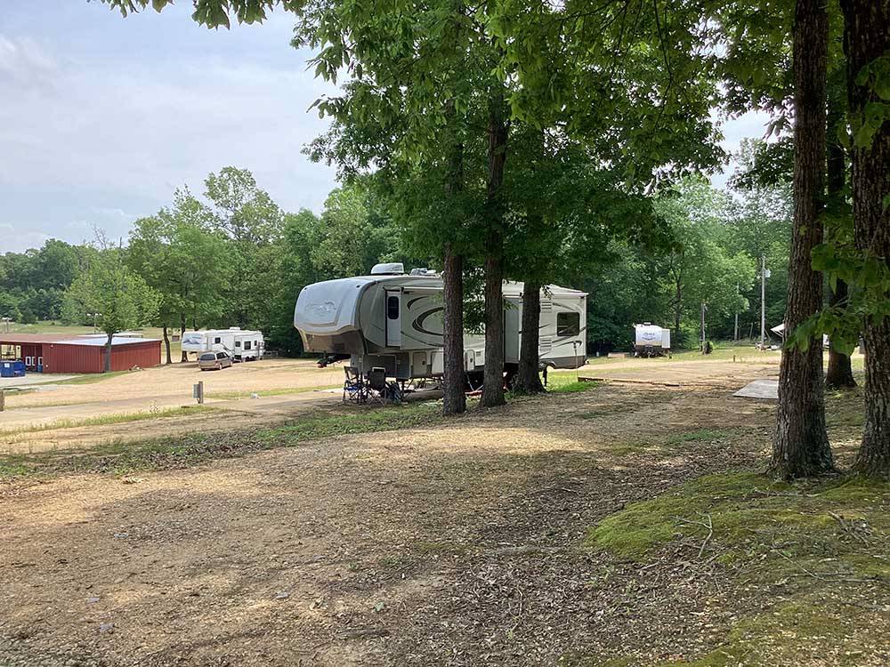 A fifth wheel trailer parked in a gravel site at CORINTH RV PARK