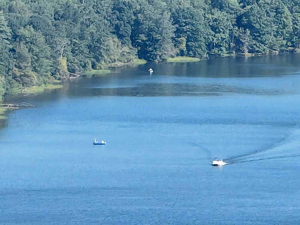 A couple of boats in the lake fishing at GLENDALE VALLEY CAMPGROUND