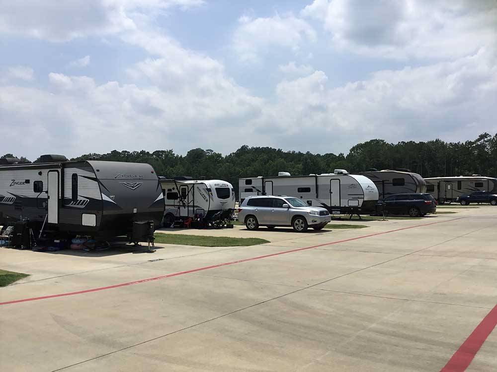 A row of trailers in paved sites at LAUREL SPRINGS RV RESORT