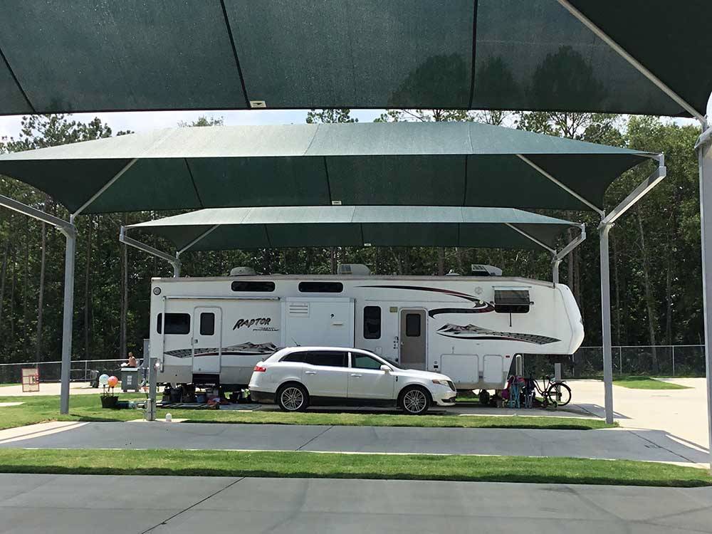 A fifth wheel trailer parked in a shaded site at LAUREL SPRINGS RV RESORT