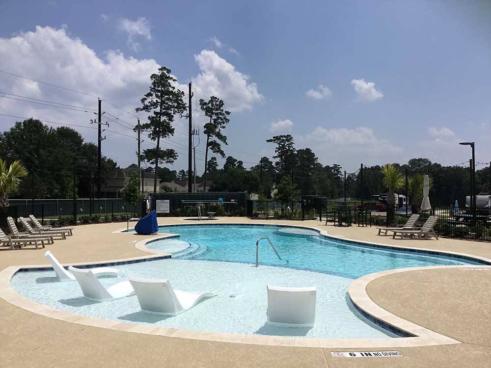 The swimming pool with seats inside at LAUREL SPRINGS RV RESORT
