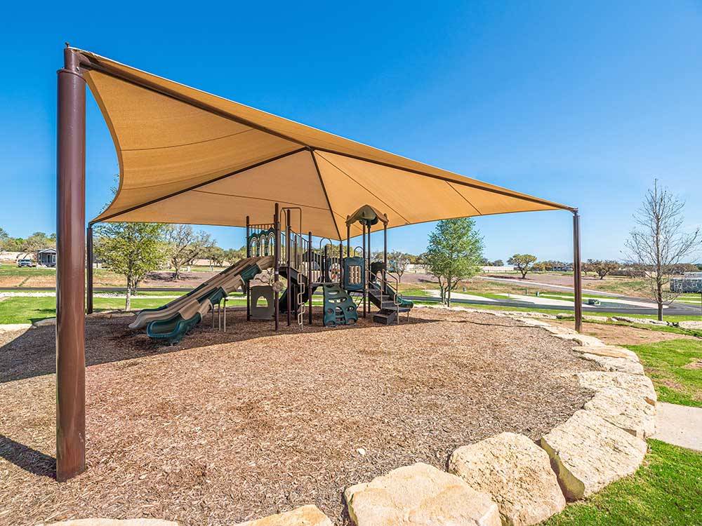 The shaded playground area at FIREFLY LUXURY RV RESORT