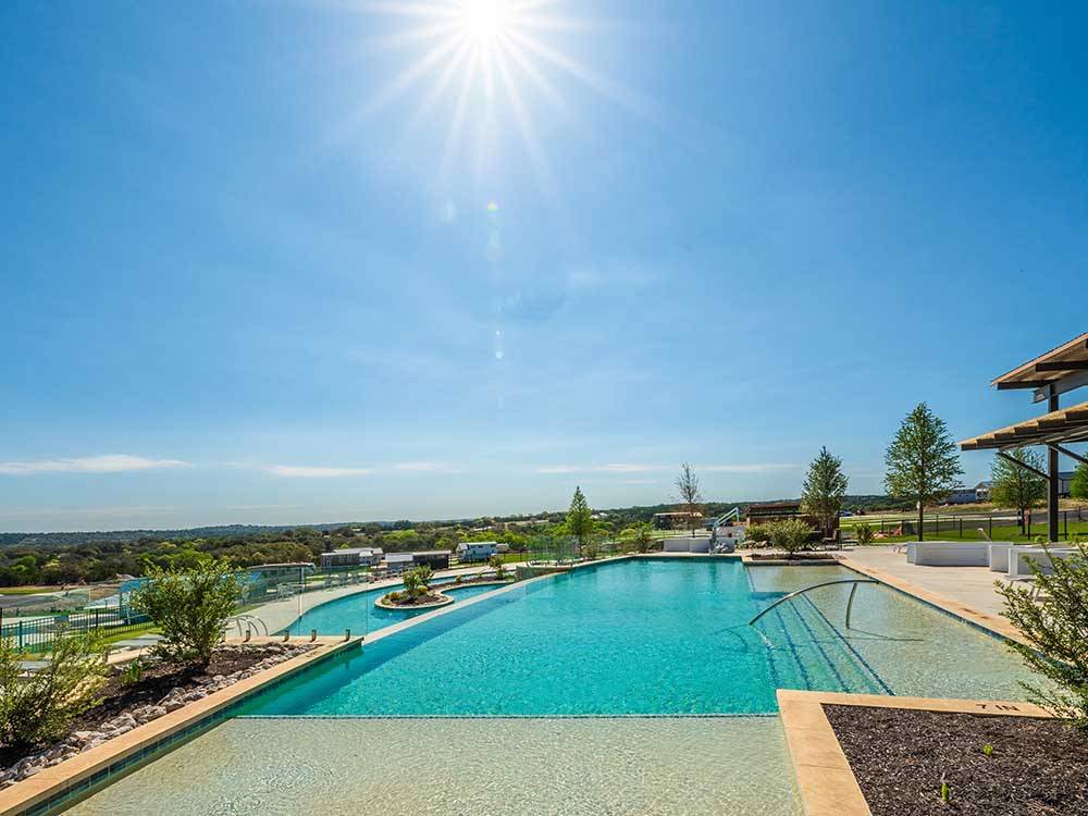 The sun in shining bright on the pool at FIREFLY LUXURY RV RESORT