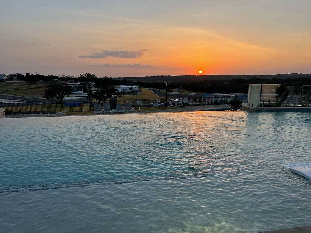The swimming pool at sunset at FIREFLY LUXURY RV RESORT