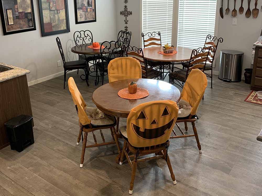 The dining area with chairs covered with pumpkin faces at ELM ACRES RV RESORT