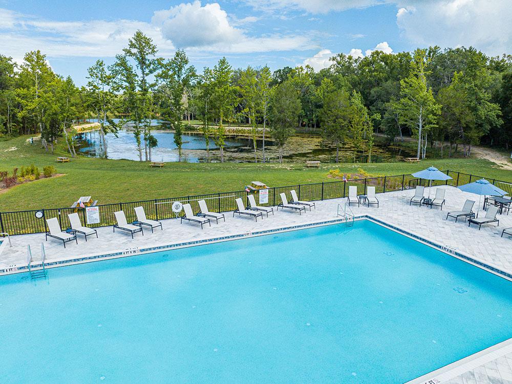 A view of the pool area and pond at SWEET CITRUS ACRES RV RESORT