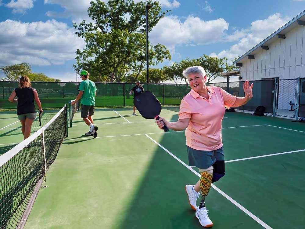 A lady just finished playing pickleball at CANOPY LUXURY RV RESORT