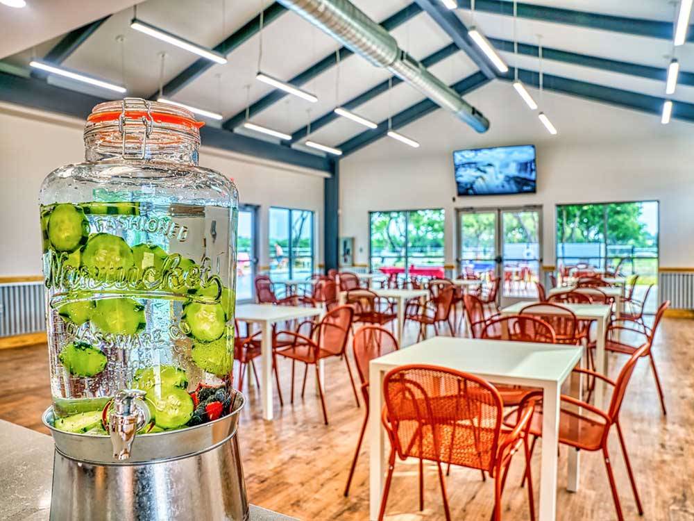 A water jug with cucumbers in the rec room at CANOPY LUXURY RV RESORT