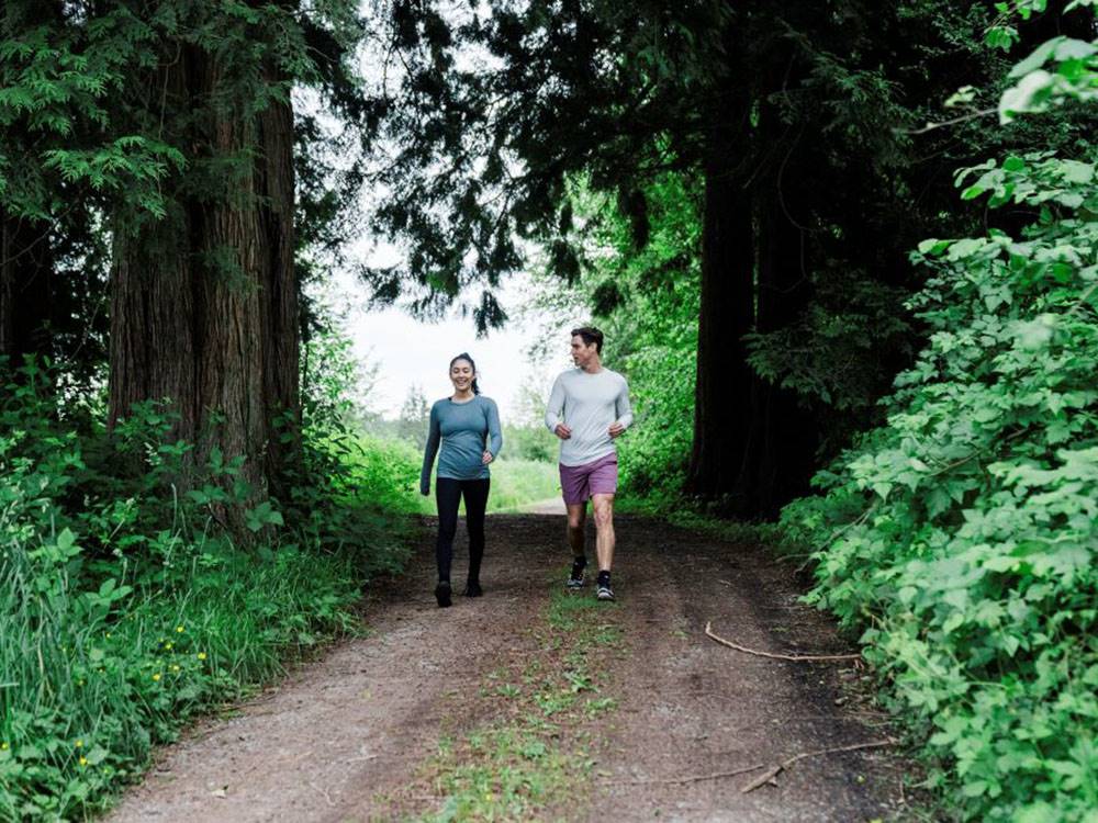 A couple walking on a nature trail at ANGEL OF THE WINDS RV RESORT