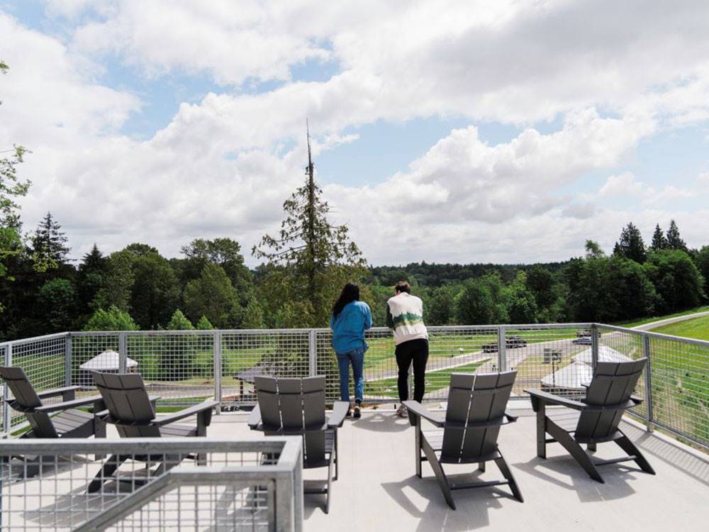 A couple enjoying the view from a patio area at ANGEL OF THE WINDS RV RESORT