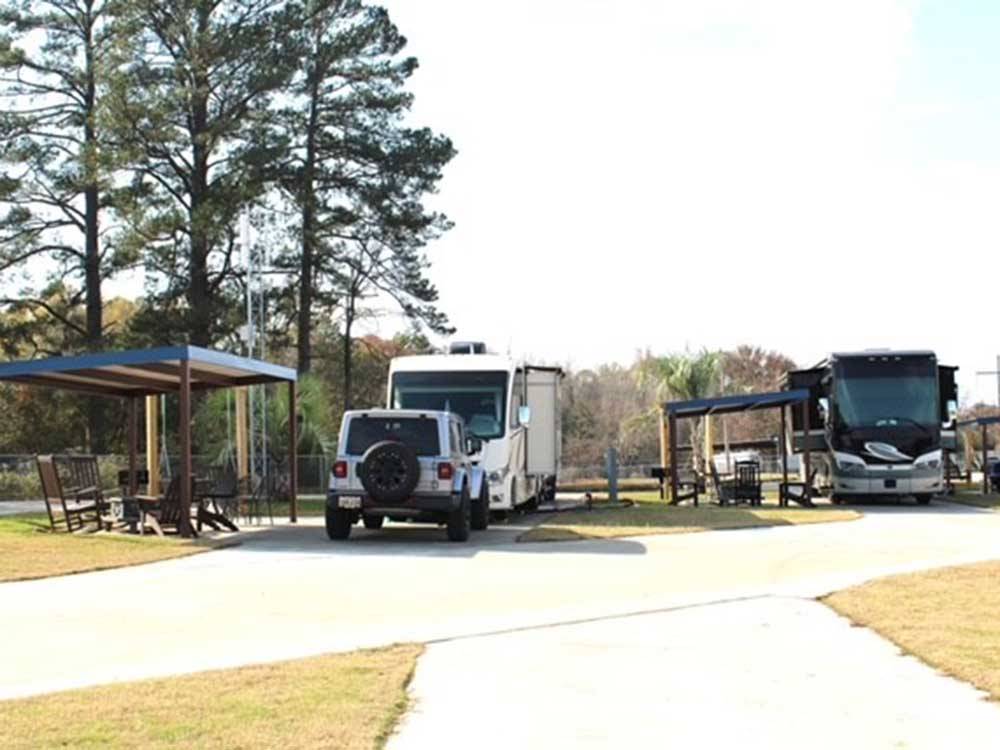 Two motorhomes parked in concrete sites at GOD'S COUNTRY RESORT