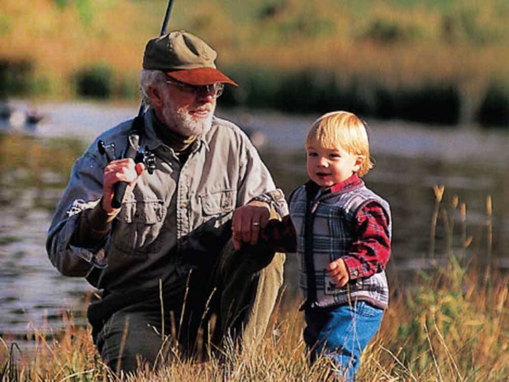 A grandpa and grandson fishing at FALL CREEK MARINA AND CAMPGROUND