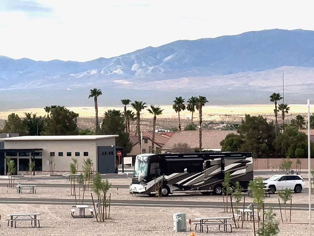 A motorhome parked in a gravel site at MESQUITE TRAILS RV RESORT